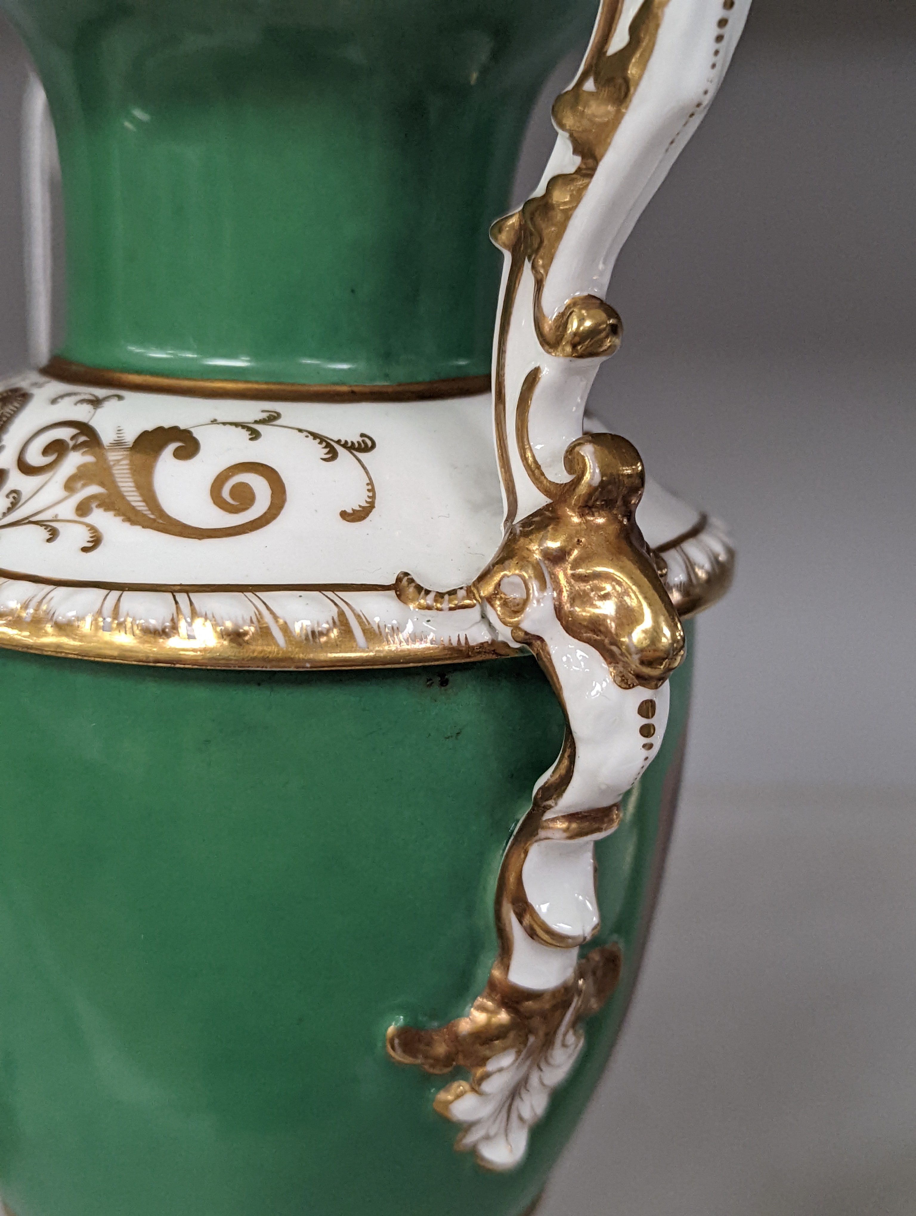 An English porcelain two handled vase painted with flowers in a panel on a green ground, probably Grainger Worcester, c.1830, height 24cm